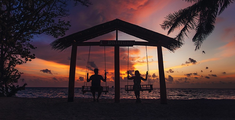 Beach swings at sunset