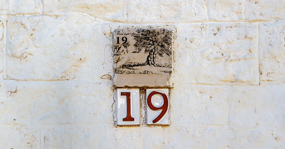 A hand-painted 19 sign on an Italian villa